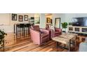 Living room featuring hardwood floors, entertainment center, and seating with a rustic coffee table at 1551 Larimer St # 704, Denver, CO 80202