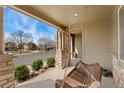 Relax on the covered front porch swing, a cozy spot to enjoy the neighborhood views at 10618 Clearview Ln, Highlands Ranch, CO 80126