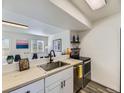 Bright kitchen featuring stainless steel appliances and an open view to the living room at 12172 E Kepner Pl, Aurora, CO 80012