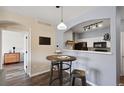 Modern kitchen with white cabinets and black appliances at 5255 Memphis St # 207, Denver, CO 80239