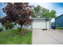 Charming single Gathering home featuring an attached garage, well-maintained lawn and mature landscaping at 10050 Holland Ct, Broomfield, CO 80021