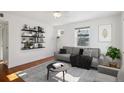 Bright living room with hardwood floors, comfy sofa, and built-in shelving at 3044 Eudora St, Denver, CO 80207