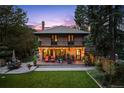 Rear view of a brick home with a large backyard and outdoor seating area at 1040 N Humboldt St, Denver, CO 80218