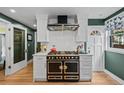 Gourmet kitchen featuring a vintage-style gas range and hood at 1040 N Humboldt St, Denver, CO 80218