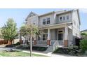 Beautiful two-story home with a cozy front porch, brick accents, and manicured lawn at 5450 Uinta St, Denver, CO 80238