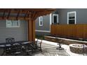 Cozy outdoor patio space, complete with a dining set, fire pit, and landscaping at 4353 Wolff St, Denver, CO 80212