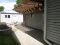 Beautiful back patio with a pergola, outdoor seating, a fireplace, and a lush garden at 4353 Wolff St, Denver, CO 80212