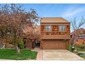 Charming two-story home featuring a two-car garage, unique wood shingle siding and front lawn at 10102 W Ida Ave # 214, Littleton, CO 80127