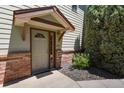 Charming front entry with brick accents and a covered porch at 11085 Huron St # 1108, Northglenn, CO 80234