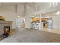 Living room with a granite fireplace, vaulted ceiling and open floor plan to the kitchen at 11085 Huron St # 1108, Northglenn, CO 80234