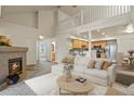 Bright living room with a fireplace, vaulted ceiling and open floor plan to the kitchen at 11085 Huron St # 1108, Northglenn, CO 80234
