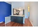 Modern kitchen with stone countertops and breakfast bar area at 1829 S Union Blvd, Lakewood, CO 80228