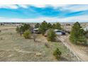 Areal view of the house and detached garage on a large lot with mature trees at 44626 Lariat Trl, Elizabeth, CO 80107