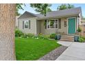 Landscaped front yard of a cozy home, showcasing lush greenery and a welcoming entrance at 4438 S Elati St, Englewood, CO 80110