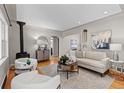 Bright living room features hardwood floors and a cozy seating area with a pellet stove at 4438 S Elati St, Englewood, CO 80110