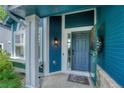 Inviting entryway with a welcoming welcome mat and a colorful wreath, leading into a lovely home at 901 Sage Sparrow Cir, Highlands Ranch, CO 80129