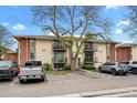 Multi-Gathering building with balconies and ample parking. A large tree shades the front at 12142 Melody Dr # 301, Denver, CO 80234