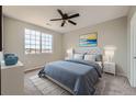Serene bedroom with large window, plush bedding, carpet flooring, and soft, natural light at 2705 S Danube Way # 306, Aurora, CO 80013