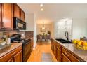 Updated kitchen featuring wood cabinets, stainless steel appliances, and a breakfast bar at 2705 S Danube Way # 306, Aurora, CO 80013