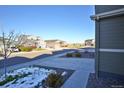 Street view showcasing a quiet neighborhood with well-maintained homes, sidewalks, and some snow at 1908 Homestead Dr, Fort Lupton, CO 80621