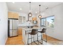 Modern kitchen featuring stainless appliances, a granite island, and stylish pendant lighting at 2958 Syracuse St # 316, Denver, CO 80238