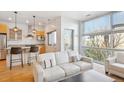 Open living room with bright light, modern decor, and a view of the outside at 2958 Syracuse St # 316, Denver, CO 80238