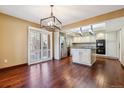 Open kitchen with granite island, stainless steel appliances, and sliding glass door at 6969 W Yale Ave # 81, Denver, CO 80227