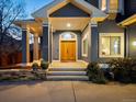 Inviting home entryway with a charming portico, wooden double doors, and professionally landscaped surroundings at 4825 6Th St, Boulder, CO 80304
