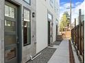 Modern townhome exterior featuring gray stone accents, modern lighting, and landscaped walkway at 1215 N Perry St, Denver, CO 80204