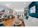 Open-concept living room with hardwood floors, modern decor, and plenty of natural light at 1215 N Perry St, Denver, CO 80204