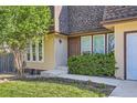 This cozy home has a well-maintained front yard, and a brown front door, with several windows at 234 Cypress Cir, Broomfield, CO 80020
