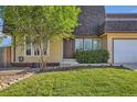 Inviting front entrance with a landscaped yard, a brown front door, and many windows at 234 Cypress Cir, Broomfield, CO 80020