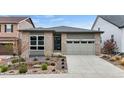Charming single Gathering home with a beautifully landscaped front yard and attached two-car garage at 9130 Fraser River, Littleton, CO 80125