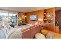 Inviting living room featuring unique wood paneling, a comfortable pink sectional sofa, and bright, colorful decor at 1090 N Lafayette St # 504, Denver, CO 80218