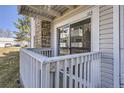 Private balcony with white railing and view of exterior, accessible through sliding glass door at 14493 E Jewell Ave # 103, Aurora, CO 80012