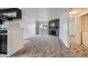 Spacious living room with fireplace, natural light, and sliding door to balcony at 14493 E Jewell Ave # 103, Aurora, CO 80012