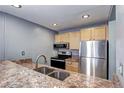This kitchen has wooden cabinets, granite countertops, and stainless appliances at 1125 N Washington St # 303, Denver, CO 80203