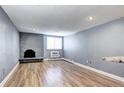 This living room has modern floors, a stone fireplace, and minimalist style at 1125 N Washington St # 303, Denver, CO 80203