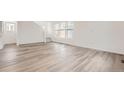 Minimalist living room with bright white walls and wide plank flooring at 2090 S Haleyville Way, Aurora, CO 80018
