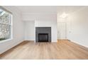 Bright living room featuring a fireplace, laminate floors and lots of natural light at 19019 E Warren Dr # H104, Aurora, CO 80013