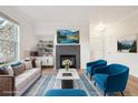 Staged living room with a fireplace, modern furnishings and lots of natural light at 19019 E Warren Dr # H104, Aurora, CO 80013