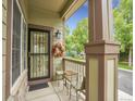 Cozy front porch with a seating area, decorative wreath, and view of the neighborhood at 4501 S Tabor Ct, Morrison, CO 80465