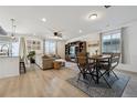 Bright and airy living room with a ceiling fan, hardwood floors, and a comfortable seating area with a sofa and a table at 131 S Vandriver Way, Aurora, CO 80018
