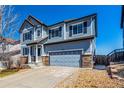 Two-story home featuring a two-car garage, neutral siding, and a well-kept lawn at 2881 Black Canyon Way, Castle Rock, CO 80109