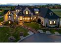 Stunning stone home featuring lush landscaping, manicured lawn and beautiful brick walkway leading to the front entrance at 15355 Zuni St, Broomfield, CO 80023
