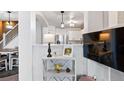 Open-concept living area showcasing a stylish console table, a staircase, and a seamless transition to the kitchen at 474 Black Feather Loop # 419, Castle Rock, CO 80104