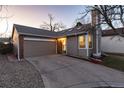 Charming home boasts a well-maintained exterior with a spacious driveway and attached garage at 9333 Cattail Ct, Highlands Ranch, CO 80126