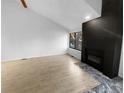 Living room with fireplace and wood-look floors at 2685 S Dayton Way # 326, Denver, CO 80231
