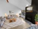 Virtually staged living room with fireplace and large window at 2685 S Dayton Way # 326, Denver, CO 80231
