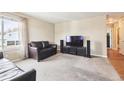 Cozy living room with neutral carpet, large window, and comfortable leather seating at 7984 Chase Cir # 68, Arvada, CO 80003